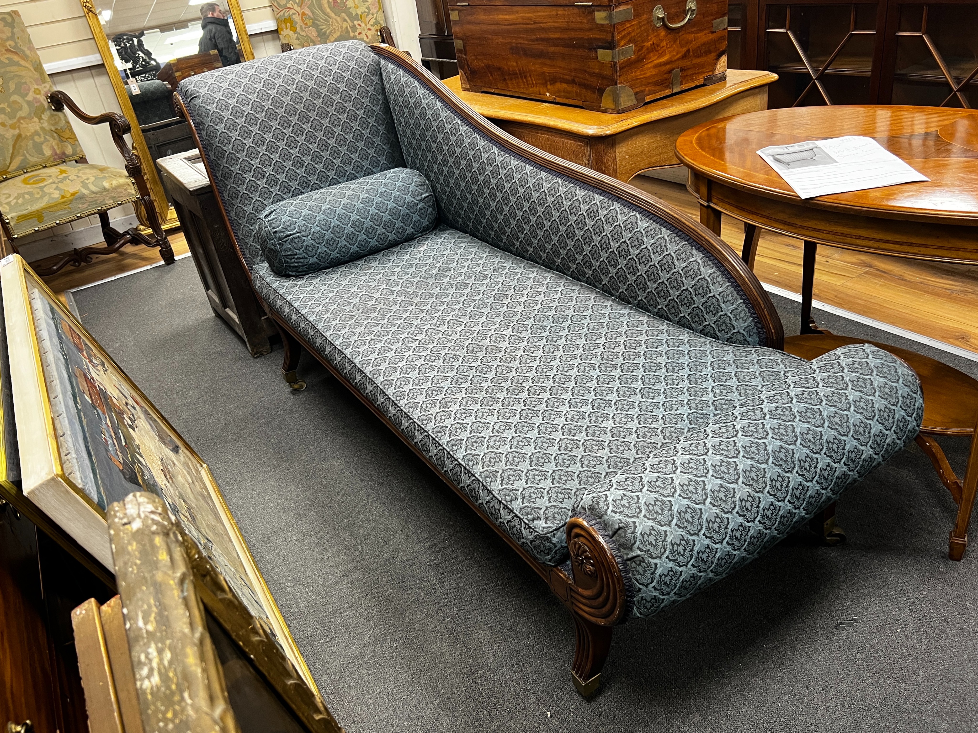 A Regency mahogany chaise longue with squab seat on fluted sabre legs width 200cm, depth 66cm, height 92cm.